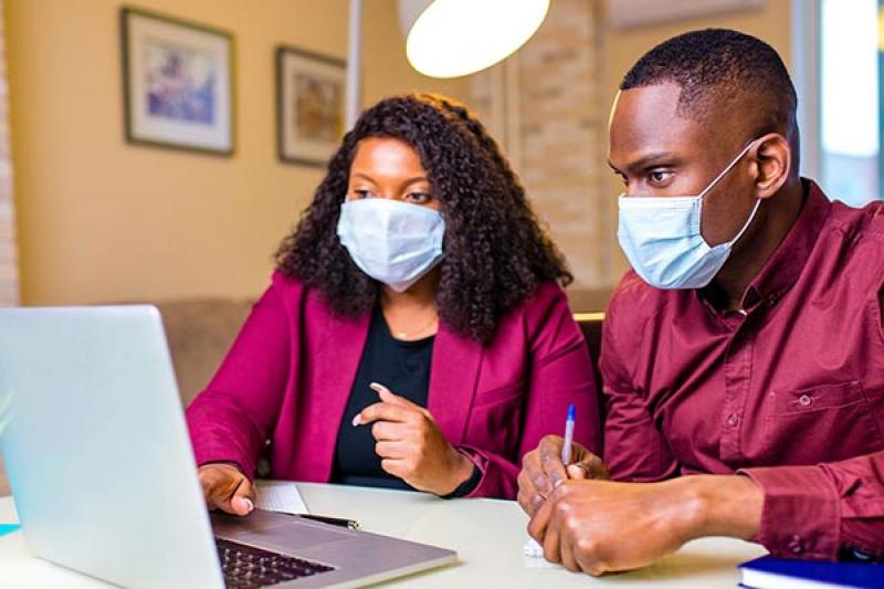 Two people looking at a computer screen