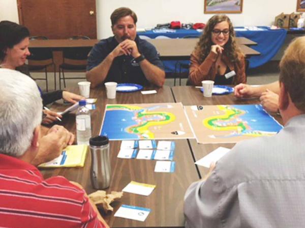 People meeting around a water flood map